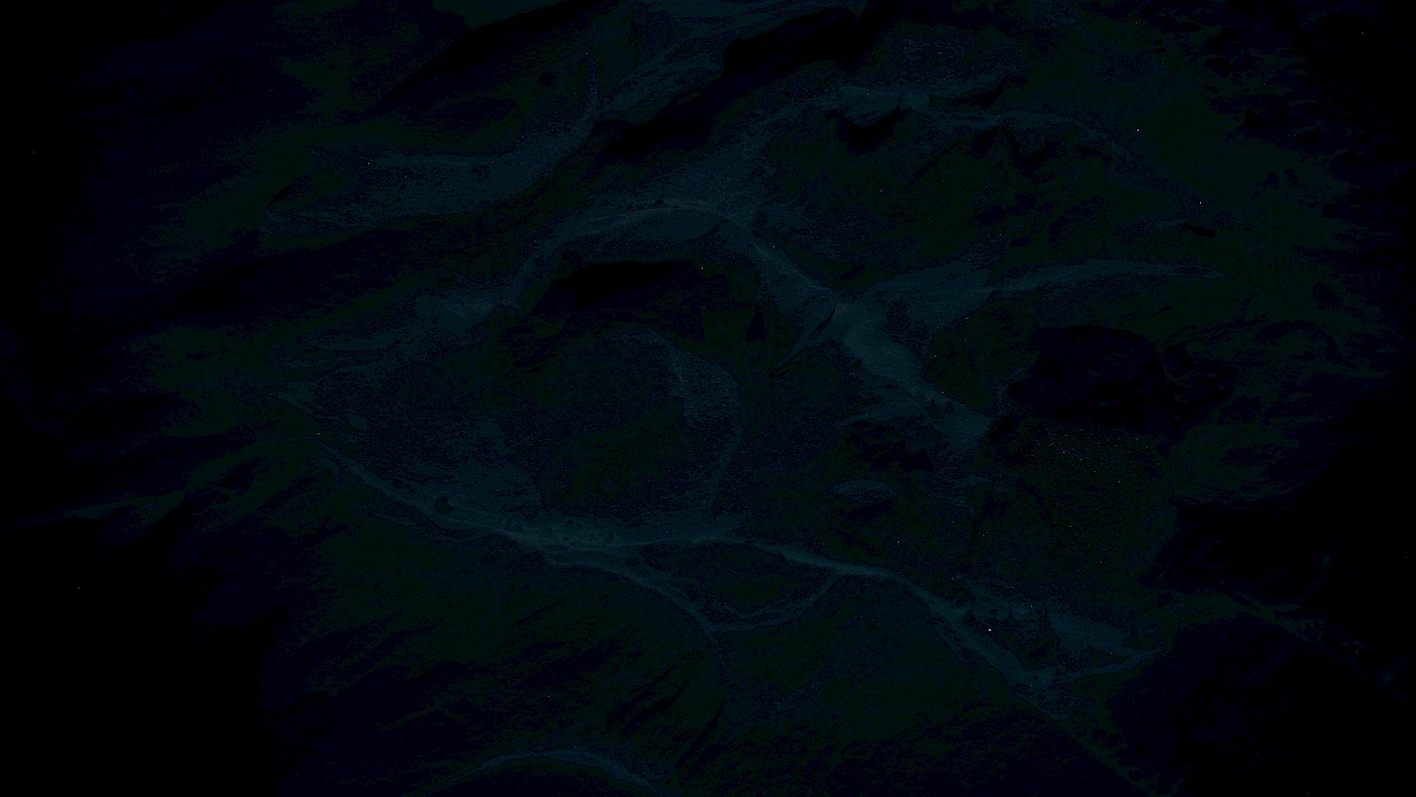 The image is dark and obscure, making it difficult to discern specific details or objects clearly within the scene.